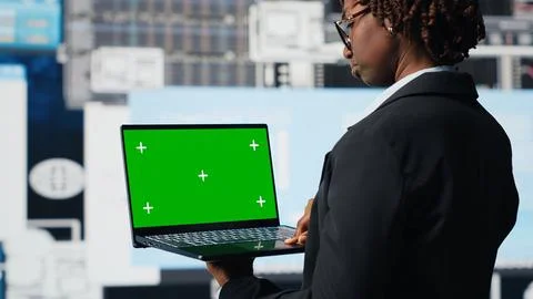 Manager using green screen laptop to compare company metrics Foto stock