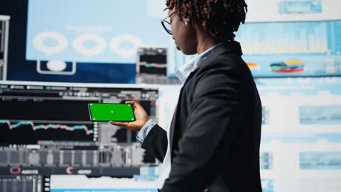 Manager using isolated screen smartphone to compare company metrics Stock Photos