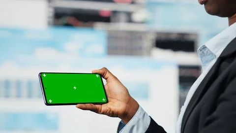 Manager using isolated screen smartphone to compare company metrics Stock Photos