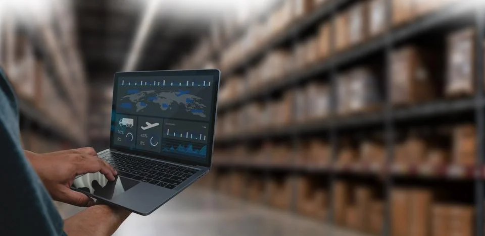 Manager using a laptop with an AI logistics dashboard in a warehouse, showi.. Stock Photos