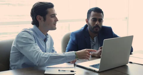 Manager using laptop showing on-line presentation to client Stock Footage 252192068