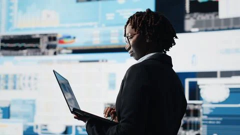 Manager using laptop software to compare company metrics Foto stock