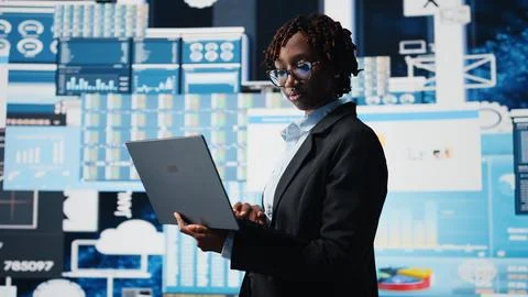 Manager using laptop software to compare company metrics Foto stock