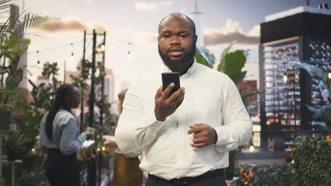 Manager using smartphone to have online conversation with business partners Stock Photos