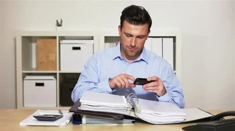 Manager using smartphone at work Stock Footage 11134917
