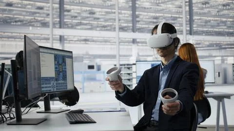 Manager using VR technology to optimize microchip production in factory Stock Photos