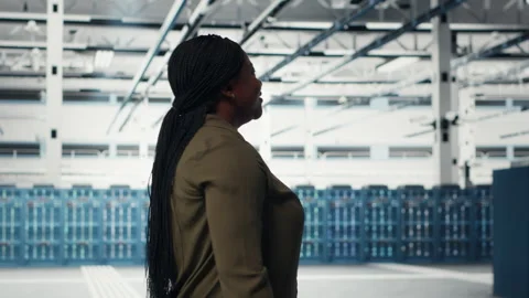 Manager walking in data center, overseeing large scale IT hardware Stock Footage 317204694