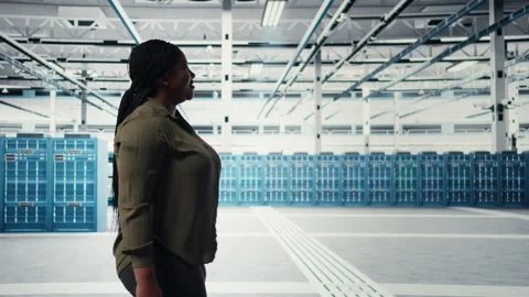 Manager walking in data center, overseeing large scale IT hardware Stock Footage 317206793
