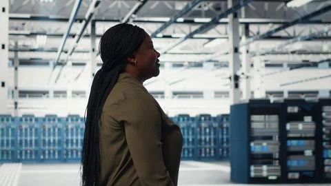 Manager walking in data center, overseeing large scale IT hardware Stock Photos