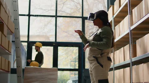 Manager in warehouse wearing VR headset Stock Footage 249706514