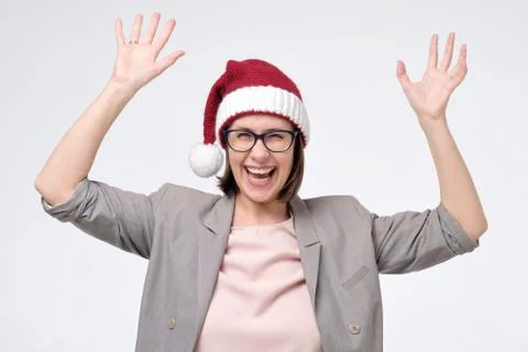 Manager woman in red Santa hat and glasses being excited with party or holidays Stock Photos