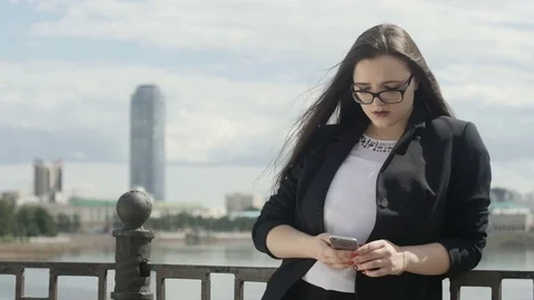 Manager woman using smartphone at handrail Видео 78534048