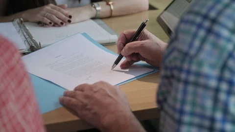 Manager Working As Banking Broker With Old Couple Signing Contract Stock Footage 99671598