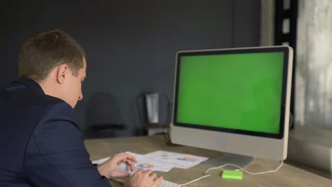 The manager is working on a green screen computer 스톡 동영상 110941950