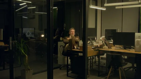 Manager Working in Office at Night and Taking Nap with Feet Up on Desk Stock Footage 331855570