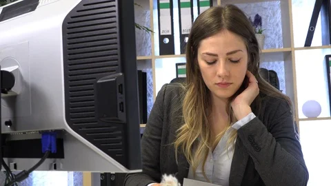 The manager writes on the computer and checks the documentation at the table. Stock-Footage 108425455