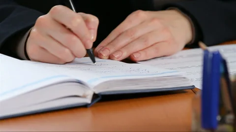 Manager writes in a notebook Stockbeeldmateriaal 30618270