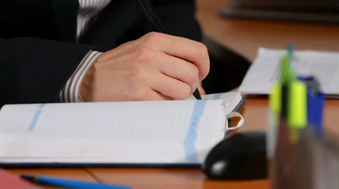 Manager writes in a notebook Stock Footage 30619722