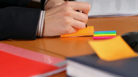 Manager writes in a notebook Stock Footage 30619742