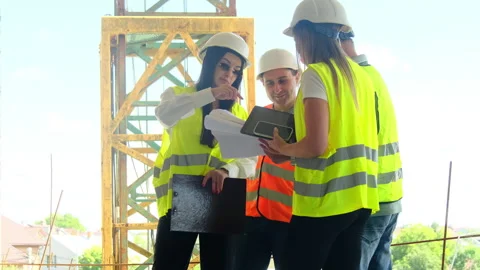 Managers and builders discuss floor plan of building Video stock 317616005