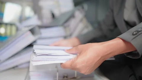 Managers are searching for and managing documents at the office. Stock Footage 148751614
