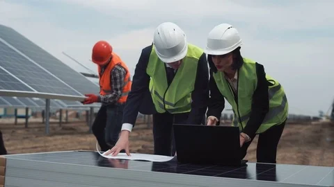 Managers with blueprint and laptop Stock-Footage 74456653