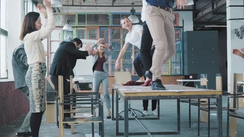 Managers celebrate the end of the project, have fun dancing on the table. Legs Stock Footage 108374320