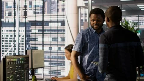 Managers evaluating work done by computer scientists in workspace 스톡 사진