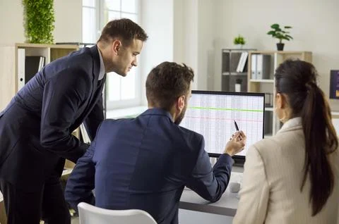 Managers review project data on computer, planning tasks and strategy in office Stock Photos