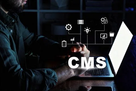 Managing content using a content management system on a laptop at night Stock Photos