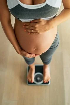 Managing healthy pregnancy weight gain with daily weigh ins. Cropped high angle Stock Photos