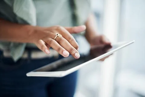 Managing my schedule with a simple tap. an unrecognizable businesswoman standing Stock Photos