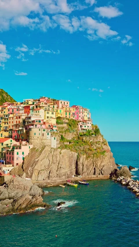 Manarola perched on cliffs above blue water in spring sunlight Stock Footage 333851336