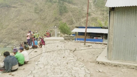 MANASLU, NEPAL - MARCH, 2018: Local people seat in the village and discuss their Video stock 94584994