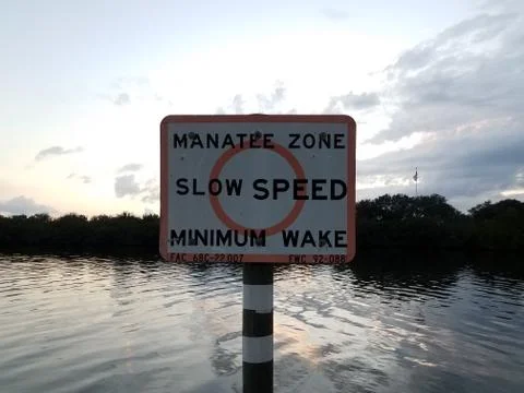 Manatee zone slow speed minimum wake sign Stock Photos