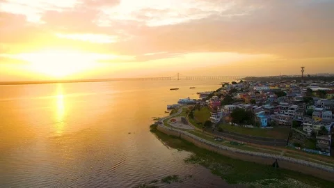 MANAUS, AMAZONAS, BRAZIL - 01/10/2020: aerial view of Sunset with favelas beside Stock Footage