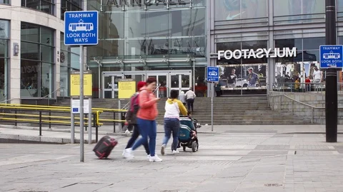 Manchester Arndale Centre Exchange Square entrance people and trams timelapse Stock Footage 107002913