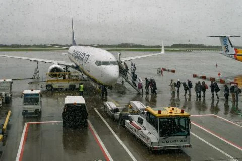 Manchester, UK Ryanair aircraft with boarding passengers at airport tarmac. Stock Photos