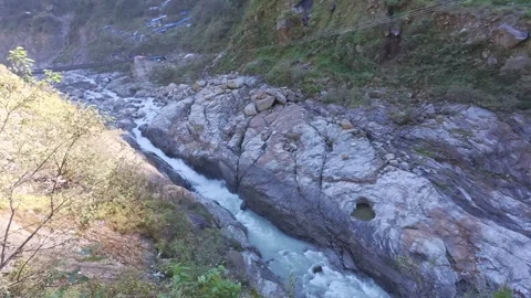 Mandakini River Rushing Through Rocky Mountain Valley during Kedarnath Trek Stock Footage 331632097