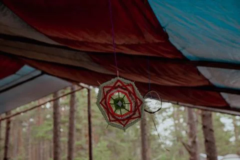Mandala hangs elegantly from the ceiling of a cozy tent Stock Photos