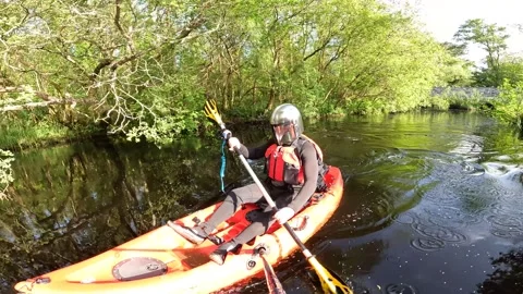 Mandalorian Kayaking down a river Stock Footage 243594897