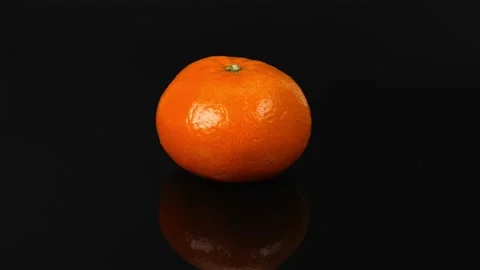 Mandarin on black background Stock Footage 220280438