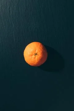 Mandarin on a black table top view Stock Photos