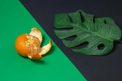 Mandarin on a colored background. Citrus fruit. Mandarin on a geometric paper ba Stock Photos