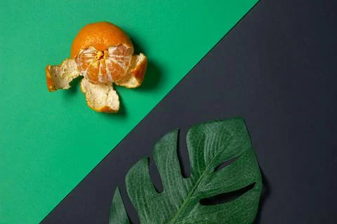 Mandarin on a colored background. Citrus fruit. Mandarin on a geometric paper ba Stock Photos