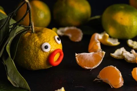 Mandarin with funny face. Stock Photos