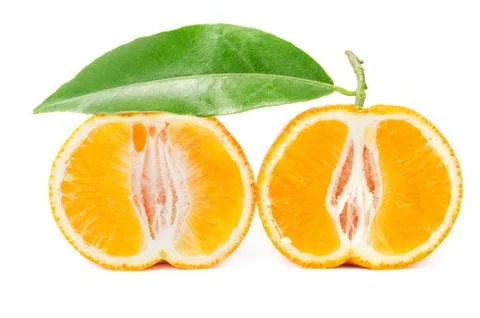 Mandarin with leaf cut in half isolated on a white Stock Photos