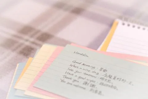 Mandarin; Learning New Language Writing Greetings on the Notebook Stock Photos