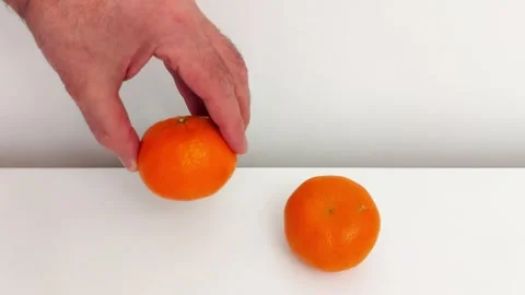 Mandarin Moment: Hand Interaction on White Surface Stock Footage 318868053