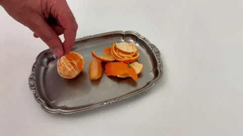 Mandarin Segments and Peel Styled on Silver Tray, White Backdrop Video stock 323259906